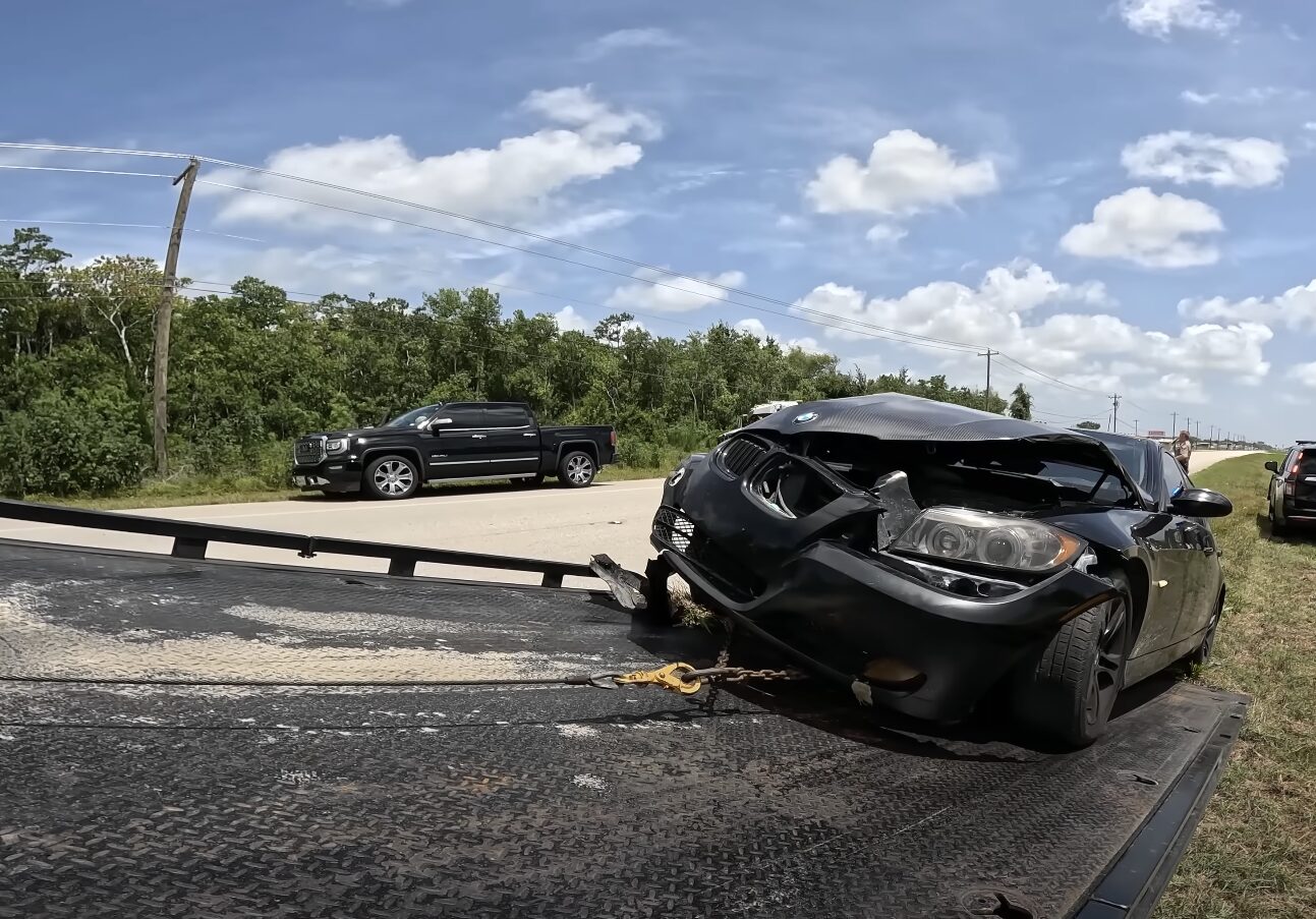 Professional car towing service loading sedan onto truck